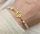 bransoletka pozłacana 1748 z globusem, perły naturalne 