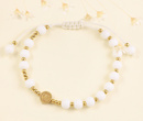 1571/12 bransoletka różaniec złota na sznureczku z porcelanowymi koralikami i krzyżem benedyktyńskim
